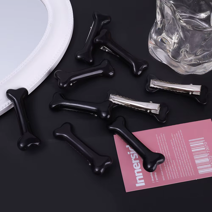 Barrettes cheveux en forme d'os noires, vues de face et de dos avec clips métalliques